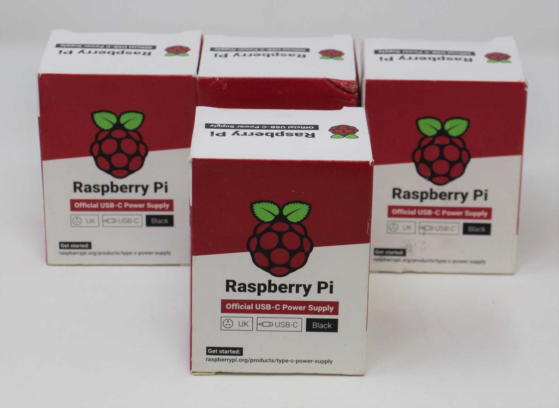 Four boxed as new Raspberry Pi 15.3W USB-C Power Supplies (UK model, Black) (Some damage to boxes).