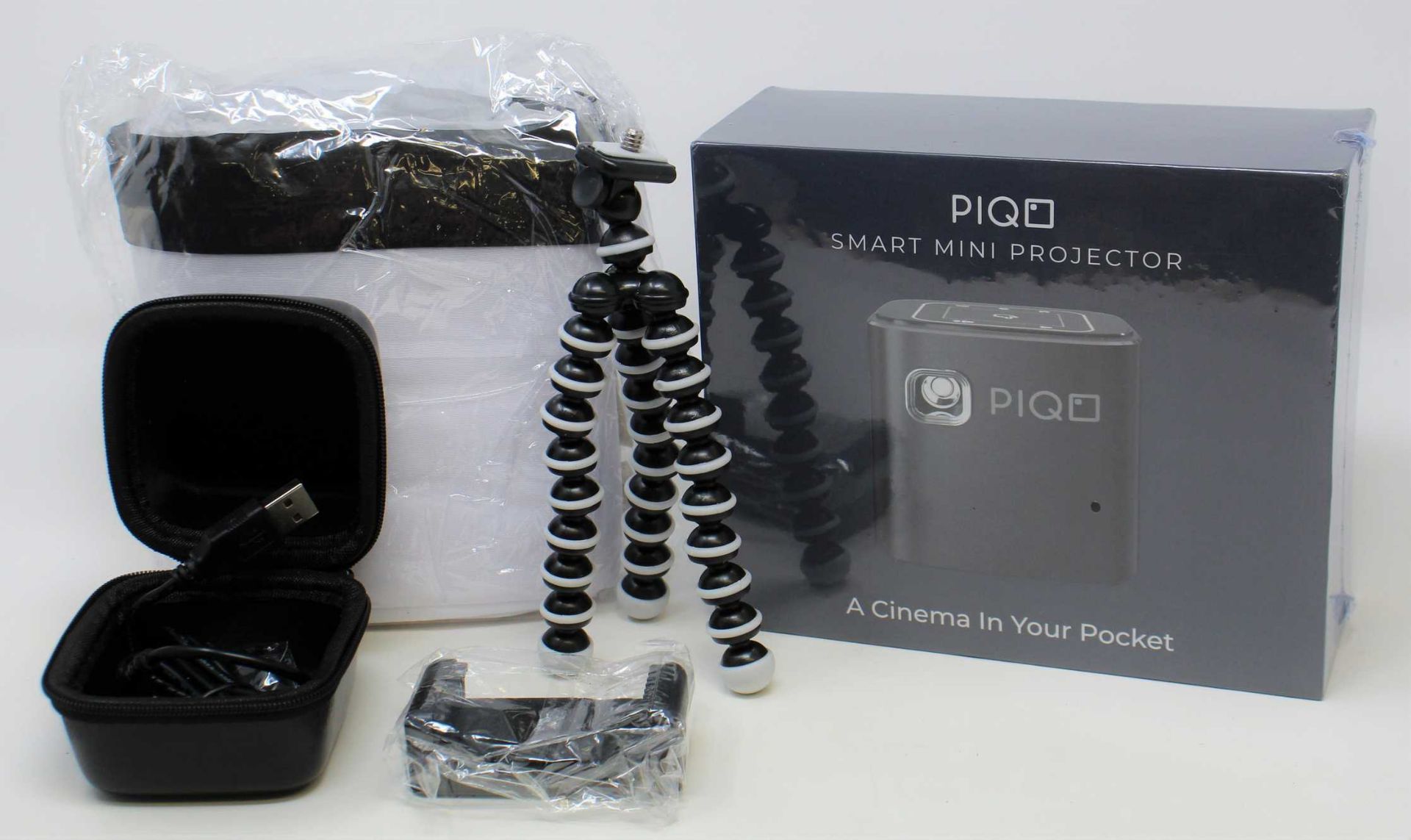 A boxed as new Piqo Smart Android Mini Projector (UK plug adaptor required) (Box sealed) with fabric