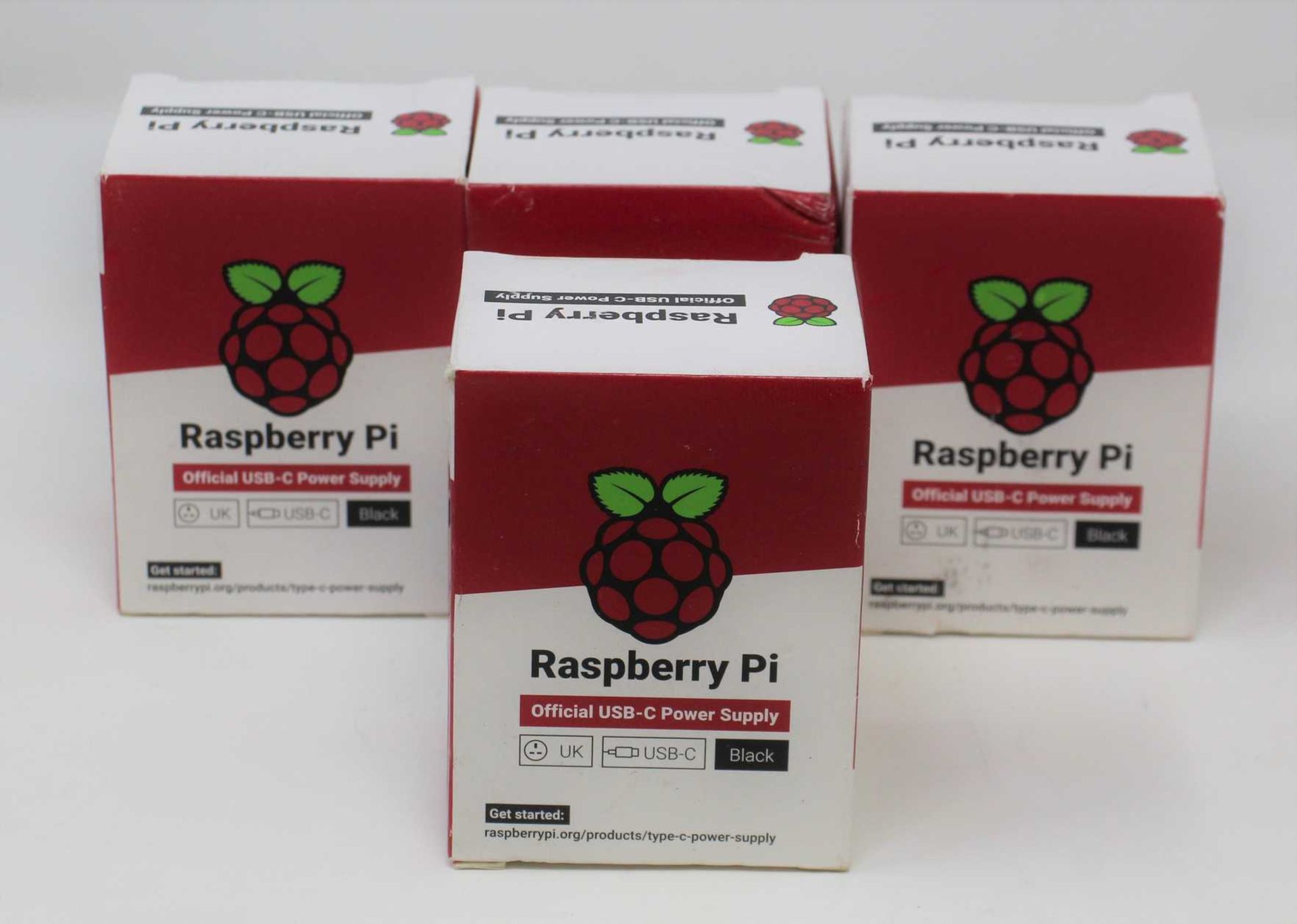 Four boxed as new Raspberry Pi 15.3W USB-C Power Supplies (UK model, Black) (Some damage to boxes).