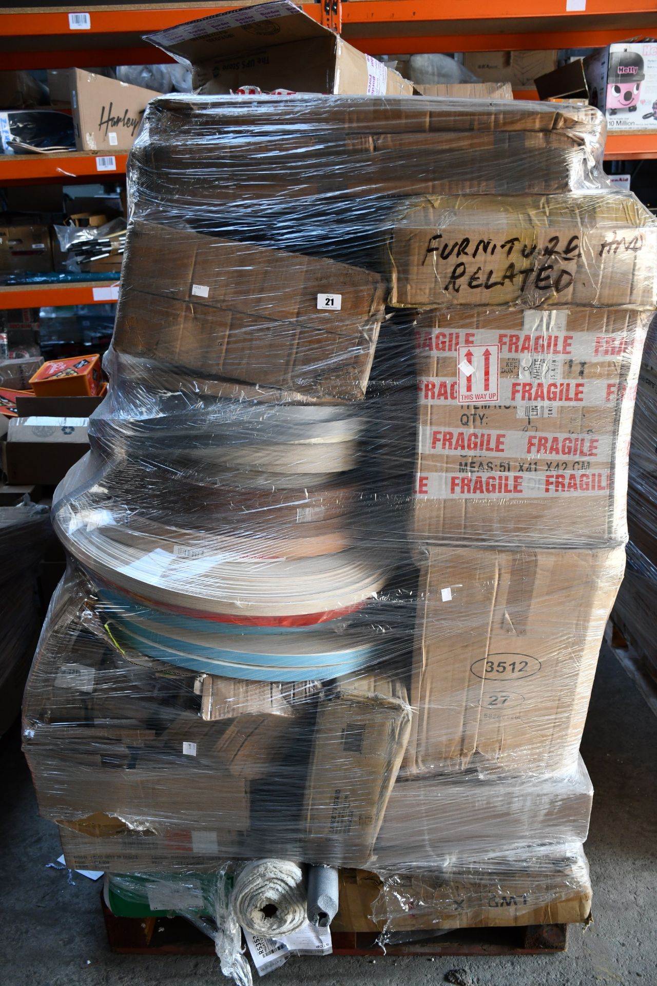 A pallet of miscellaneous flat pack furniture, household and related items.