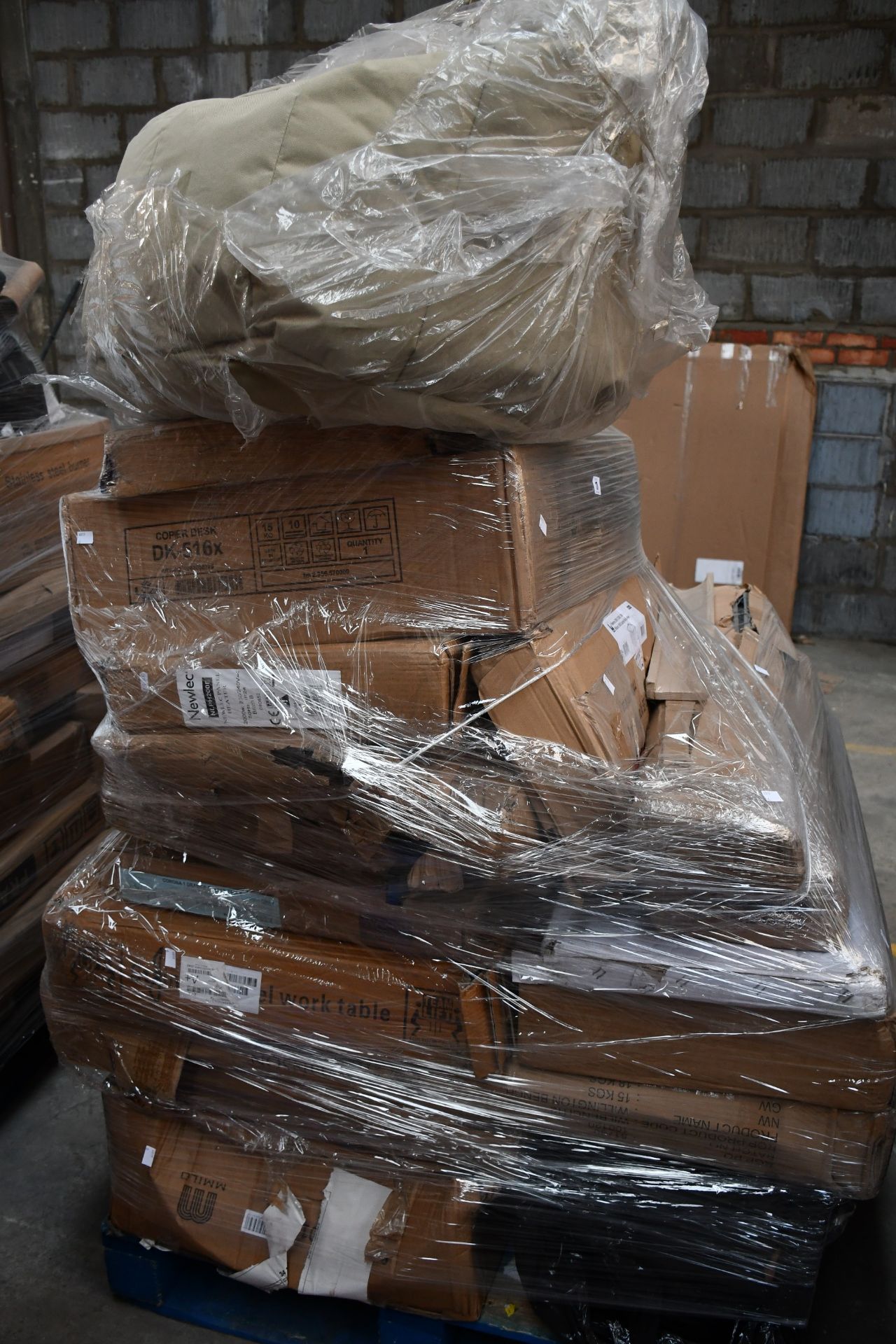 A pallet of miscellaneous flat pack furniture, household and related items.