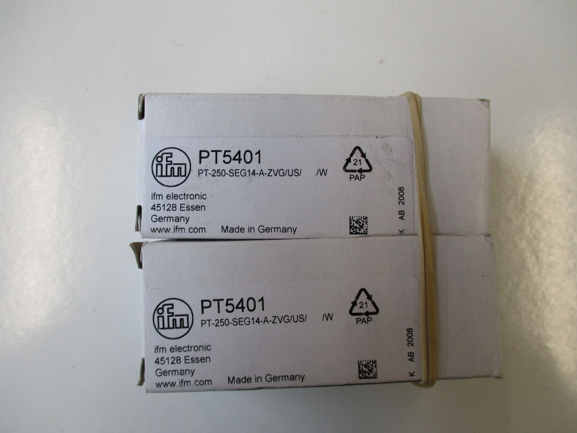 Two boxed IFM Electronic PT5401 pressure sensors.