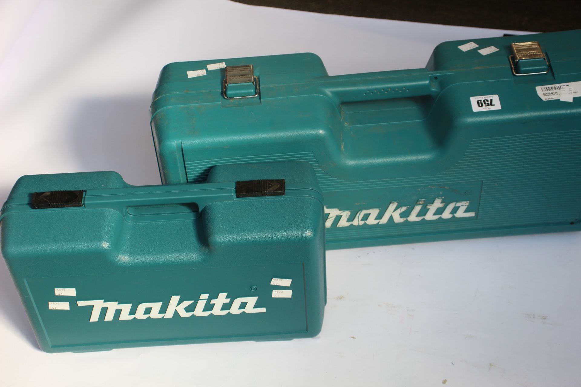 An as new Makita GA4530R Angle Grinder and a pre-owned Makita GA9020 Angle Grinder (Requires plug).