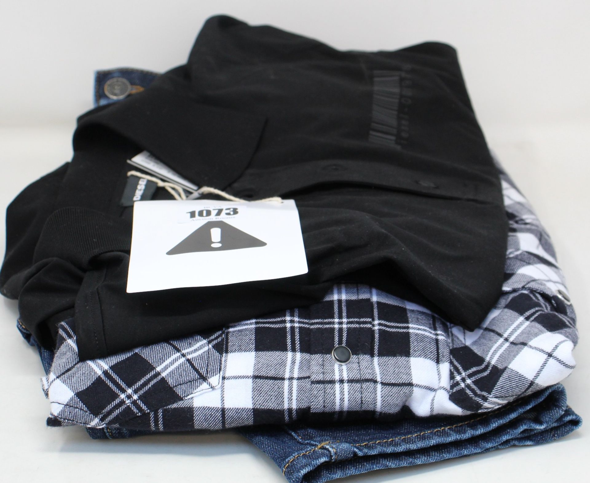 Three items of as new Diesel clothing; a pair of jeans (W30/L32), check shirt (L) and black shirt (M