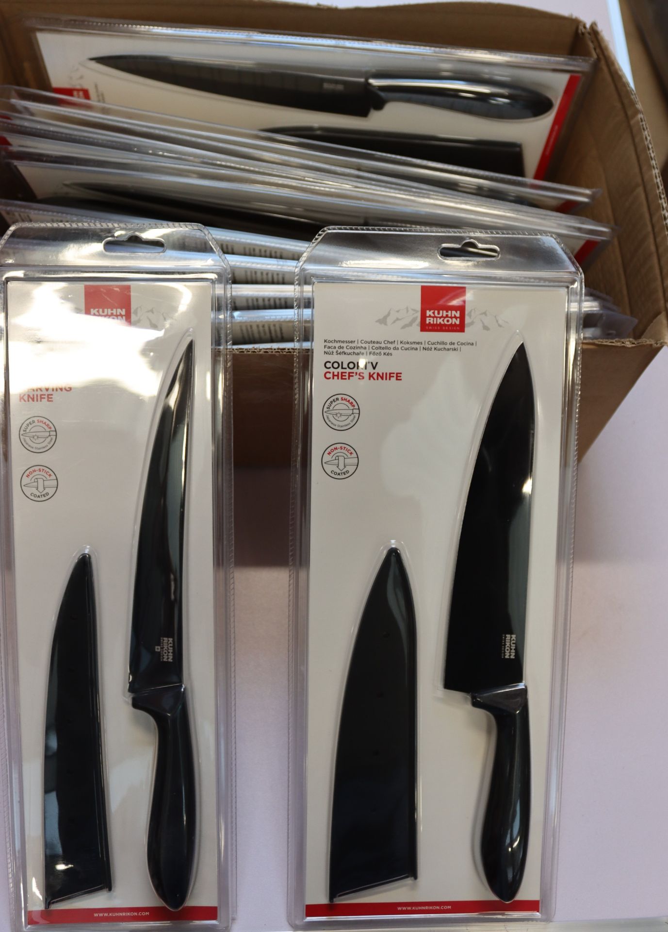 Twelve as new Kuhn Rikon knives to include six Colori V chef's knives, four Colori V carving