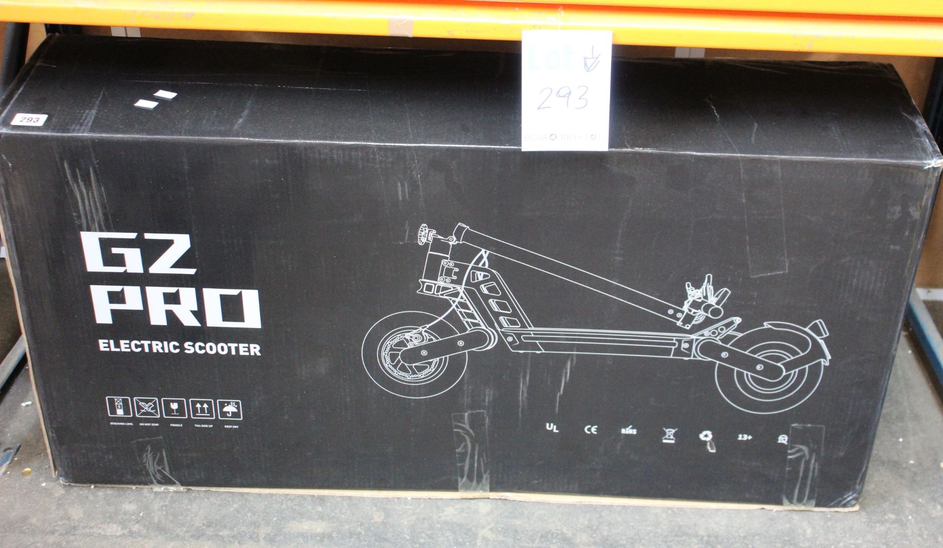 A boxed Kugoo G2 Pro electric scooter in black.
