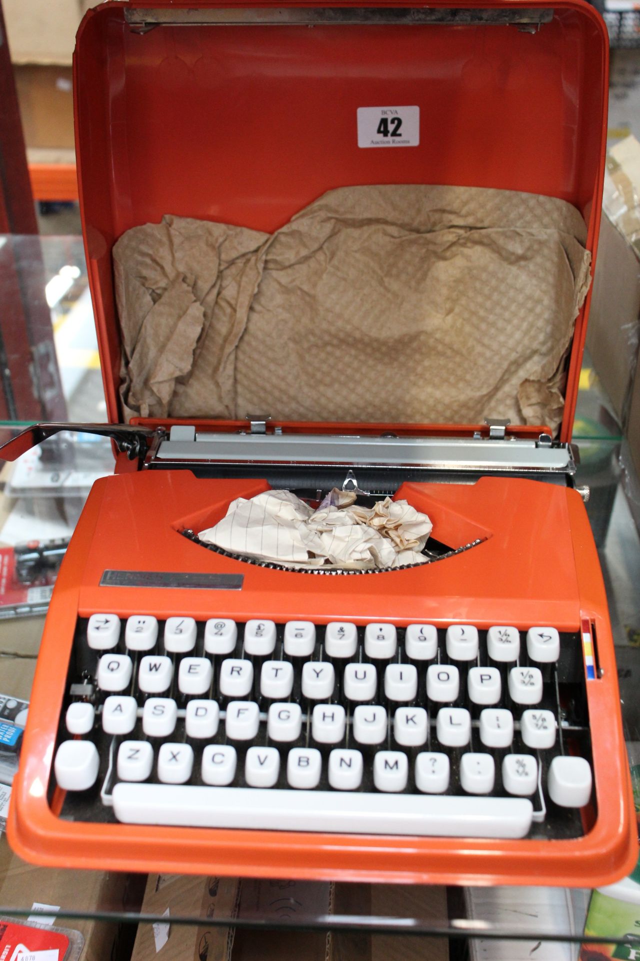 A pre owned Hermes Baby vintage typewriter in orange (Some slight damage to case).
