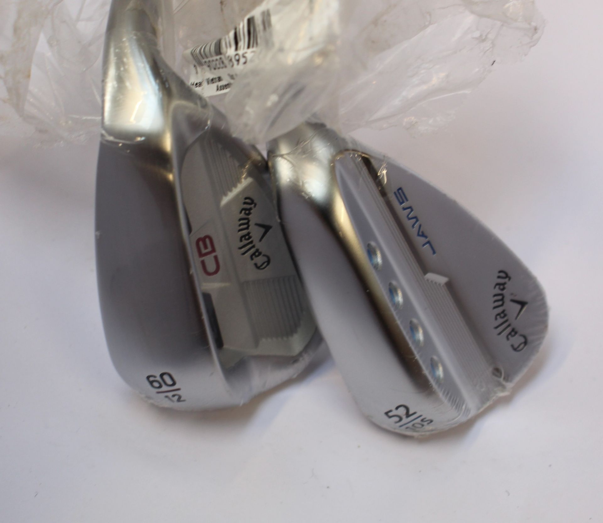 An as new Callaway Jaws MD5 52 wedge and an as new Callaway Mack Daddy CB 60 wedge (Both right-