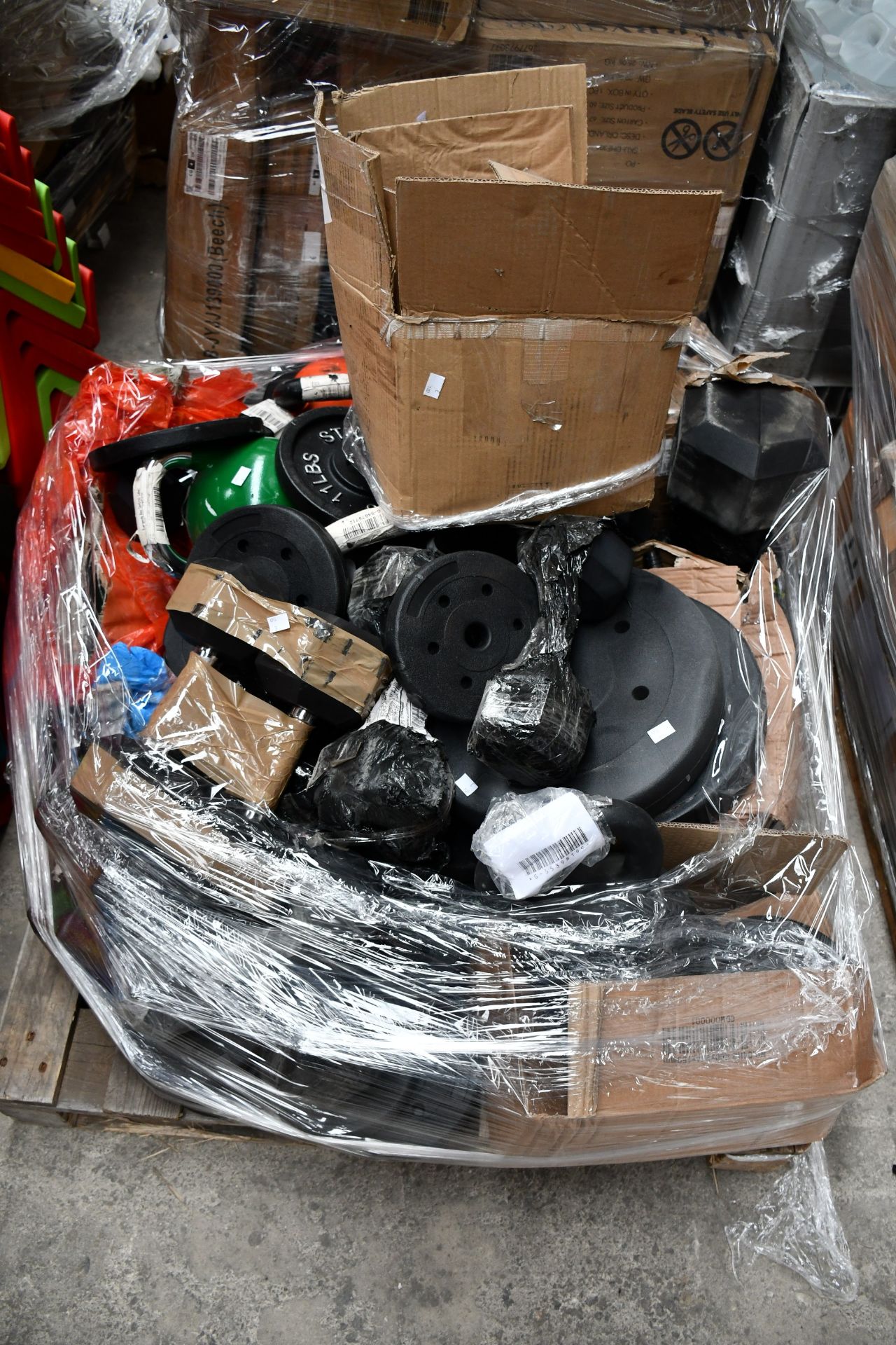 A quantity of gym weights and related items.