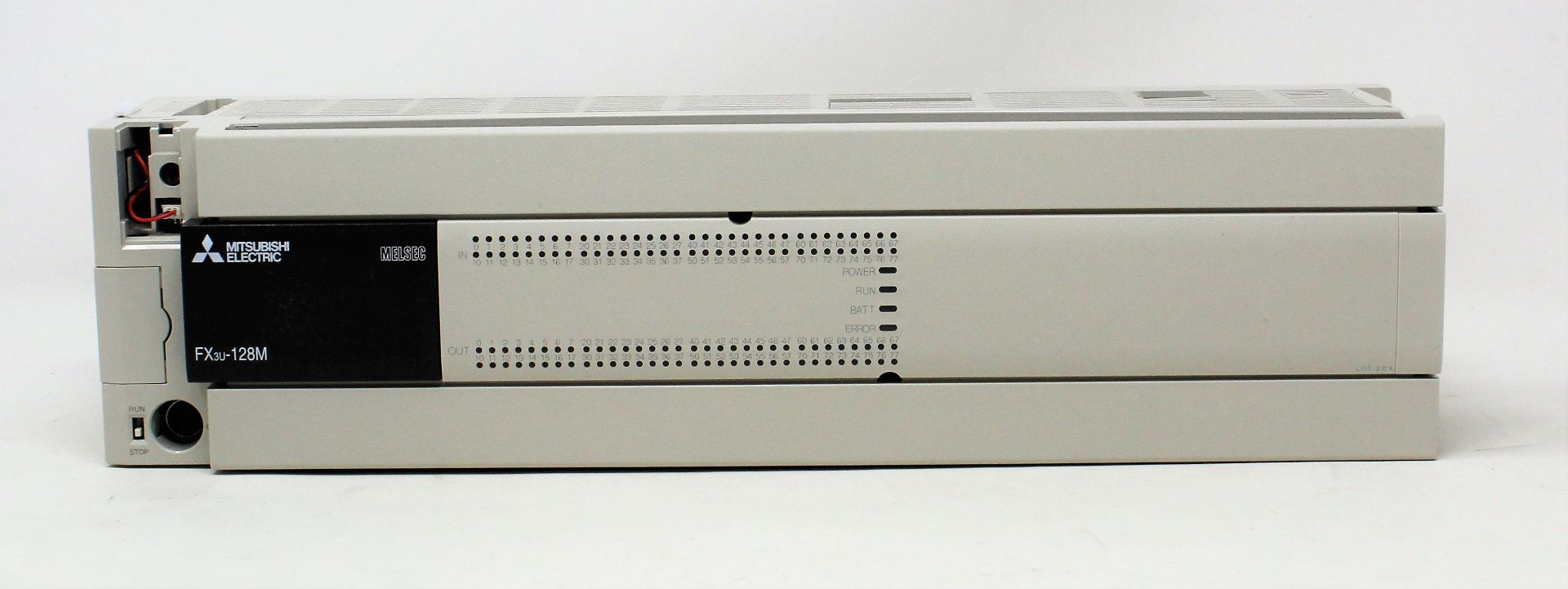 A boxed Mitsubishi MELSEC FX3U-128M programmable controller (box open, appears new)