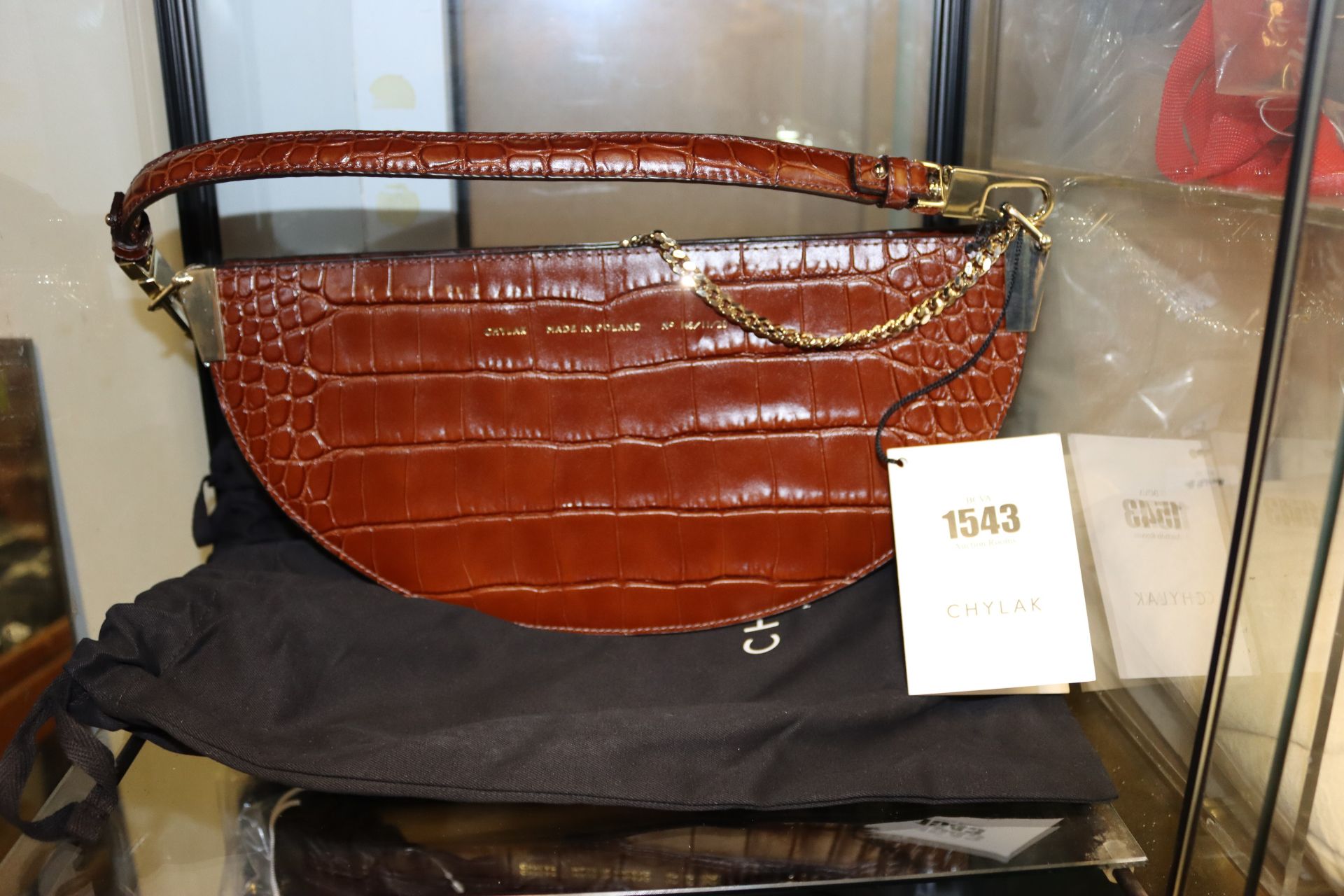 An as new Chylak saddle bag in brown crocodile leather.