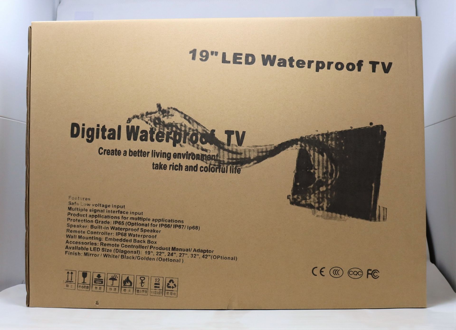 A boxed as new unbranded 19" LED waterproof TV with remote in silver. (box damaged and opened)