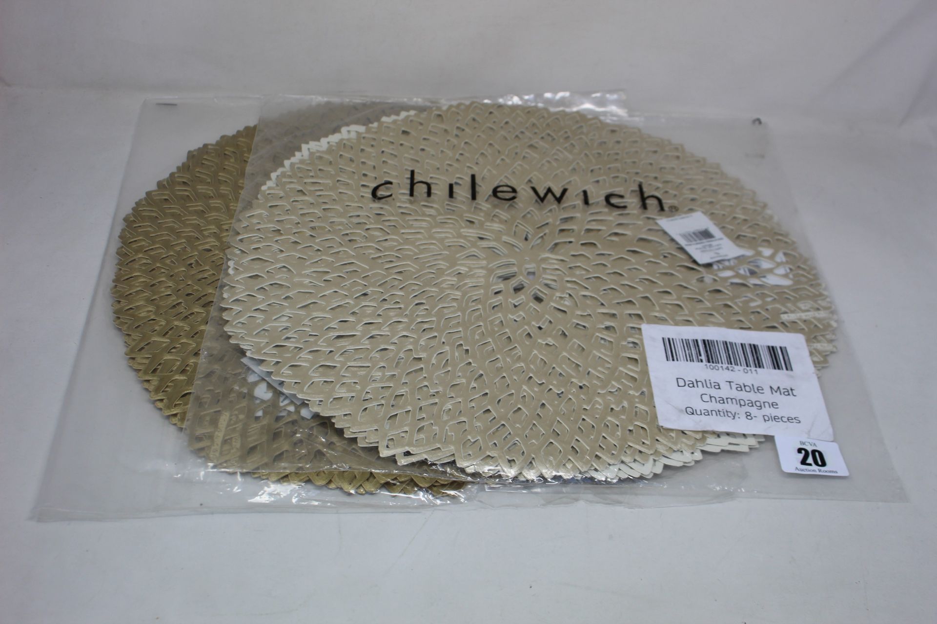 Sixteen as new Chilewich Dahlia table placemats (Six in brass, six in champagne).