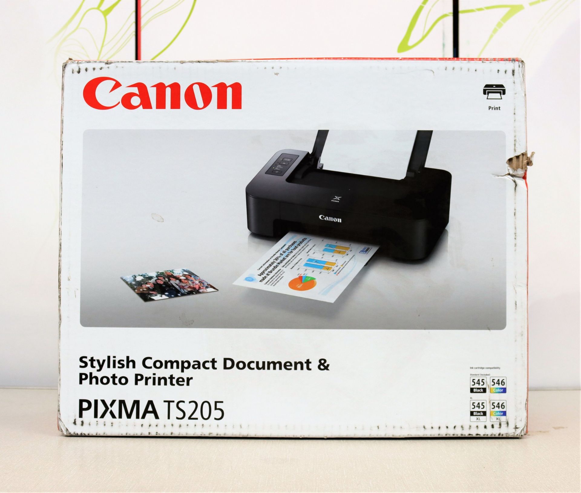 A boxed as new Canon Pixma TS205 printer in black. (box damaged)