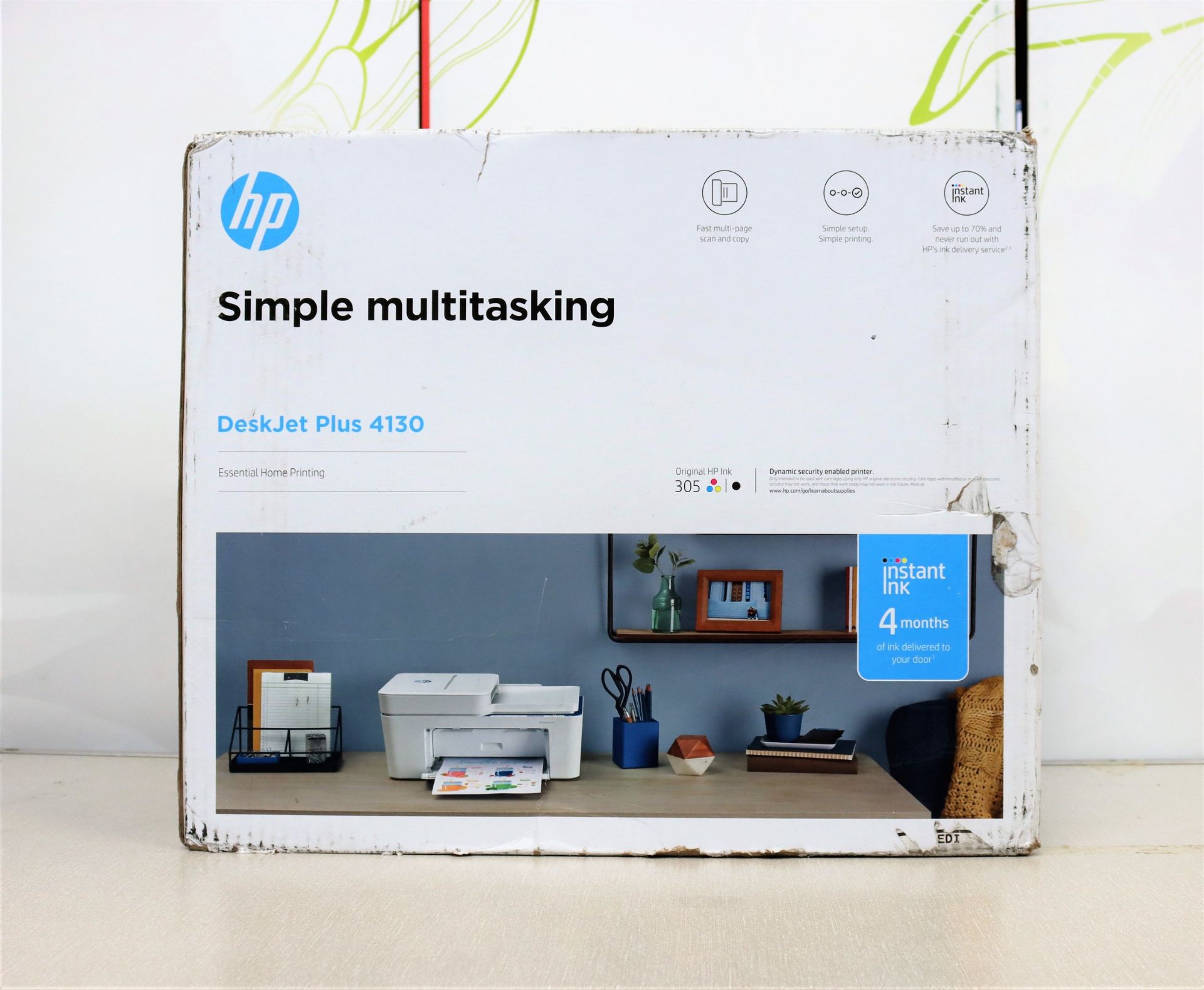 A boxed a new HP DeskJet Plus 4130 all-in-one inkjet printer in white. (box damaged)