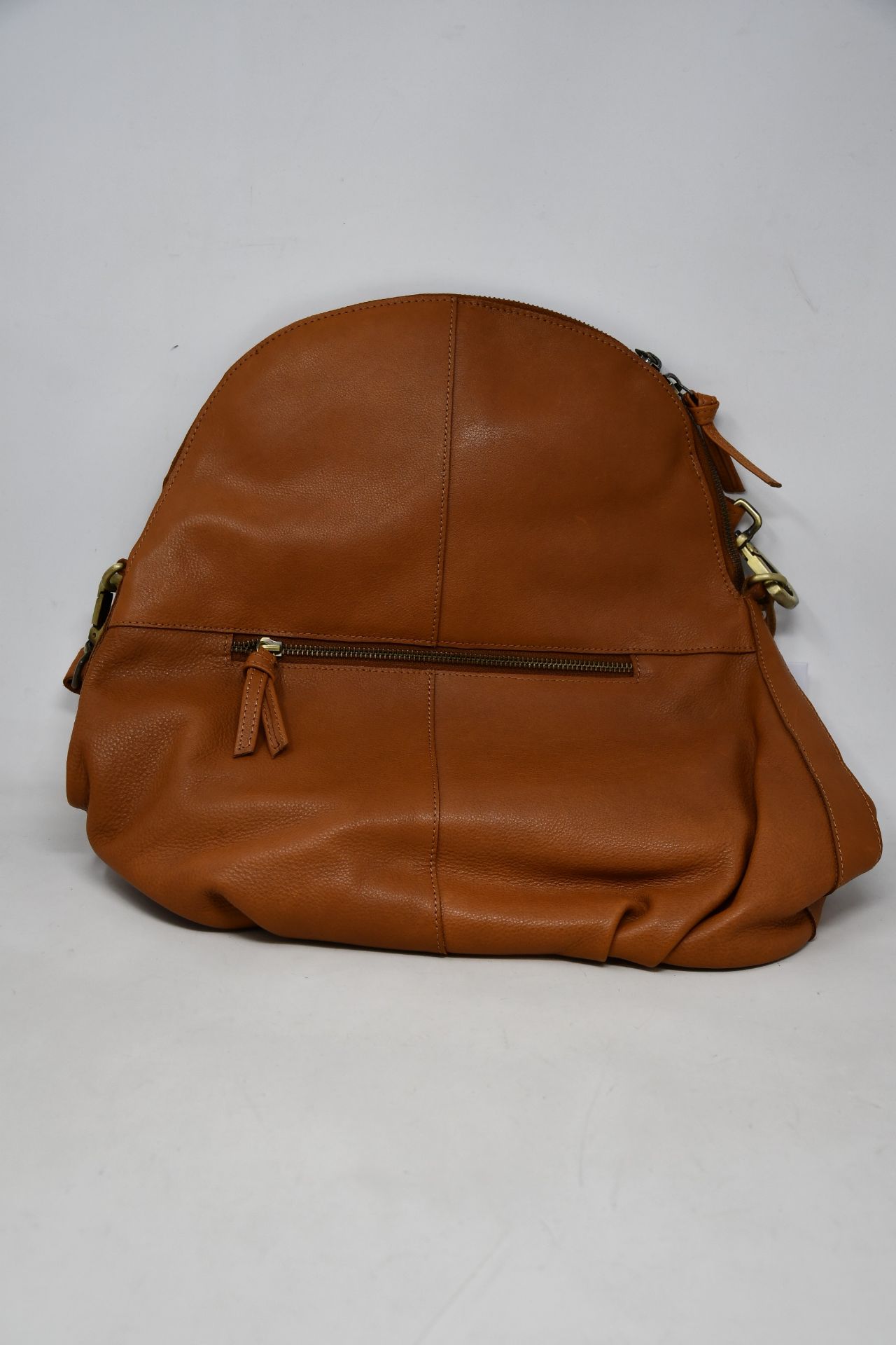 An as new Hannah Common natural tan leather back pack bag with dust cover.