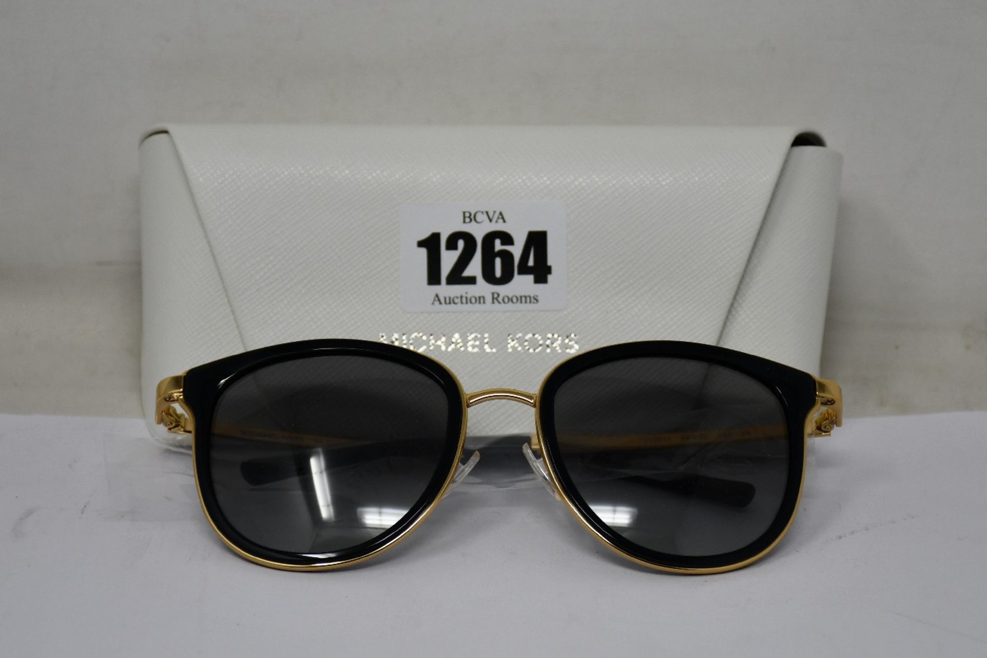 A pair of as new Michael Kors sunglasses.