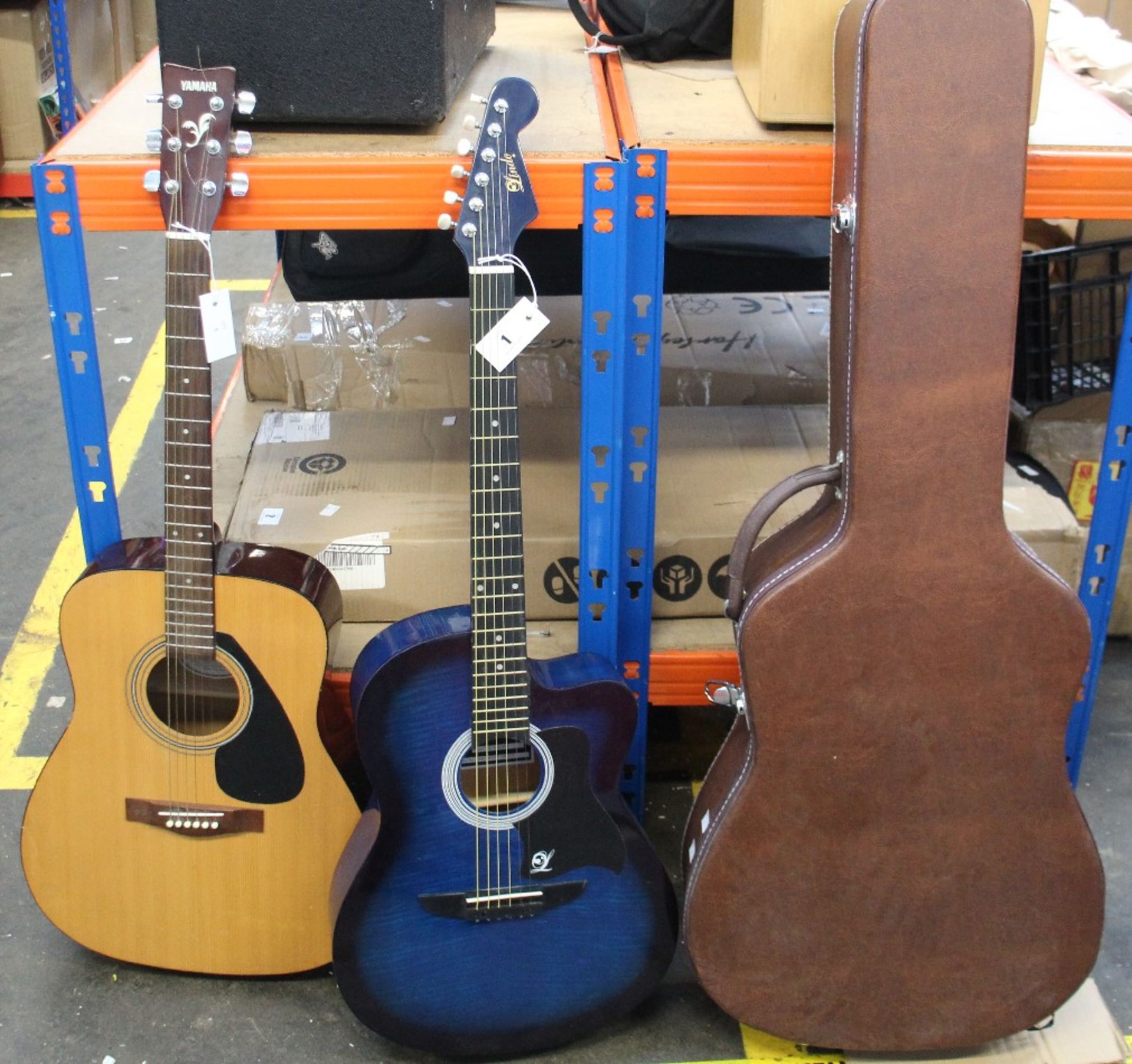 A pre-owned Lindo LDG-933CTBLS acoustic guitar and a Yamaha F-310 acoustic guitar with a hard case.