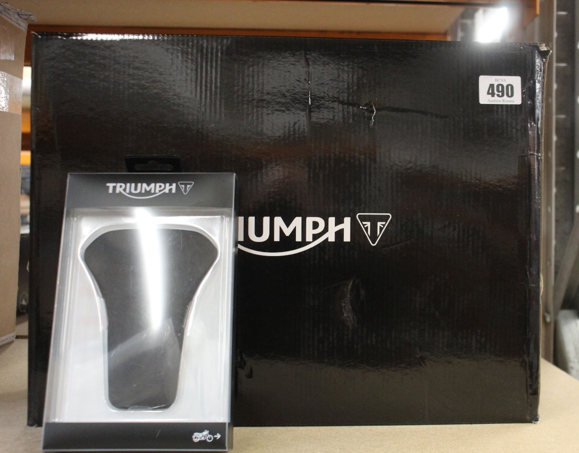 A Triumph Outdoor Bike Cover A9930494 and a Triumph Rubber Tank Pad for Speed Triple A9790116,