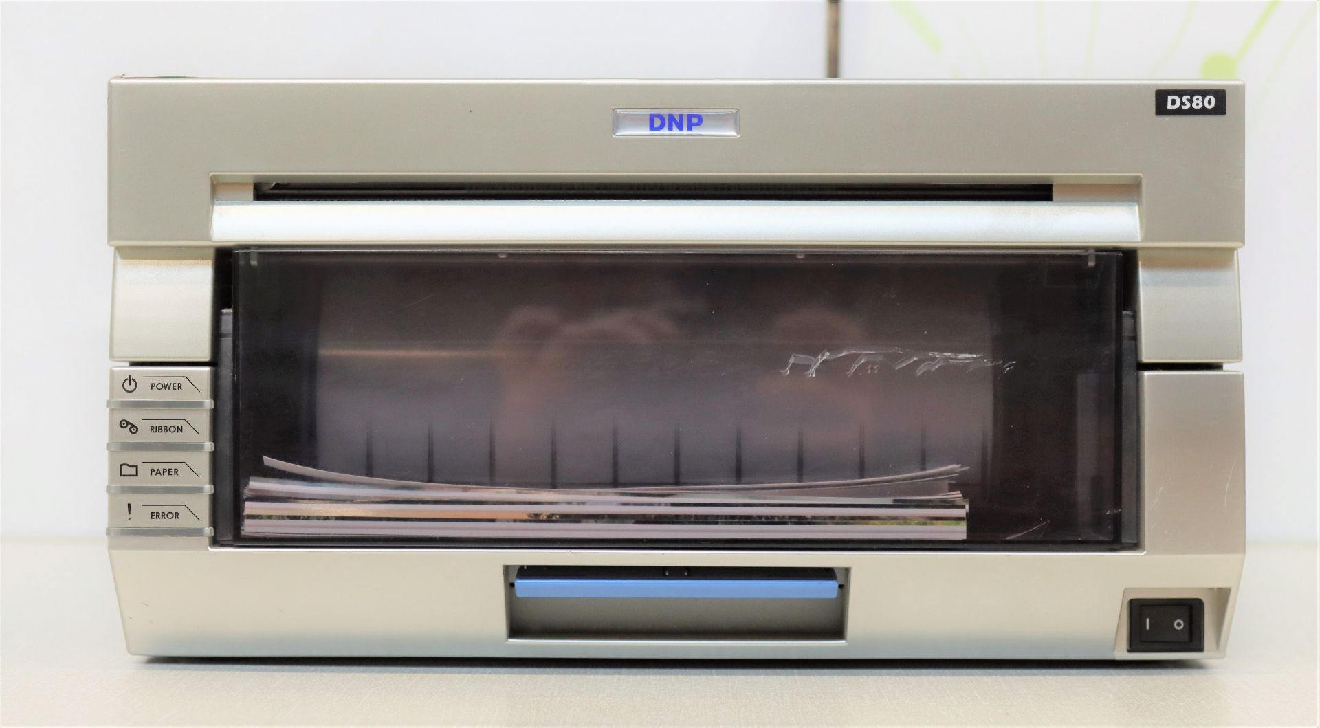 A pre-owned DNP DS40 photo printer (Some cosmetic damage).