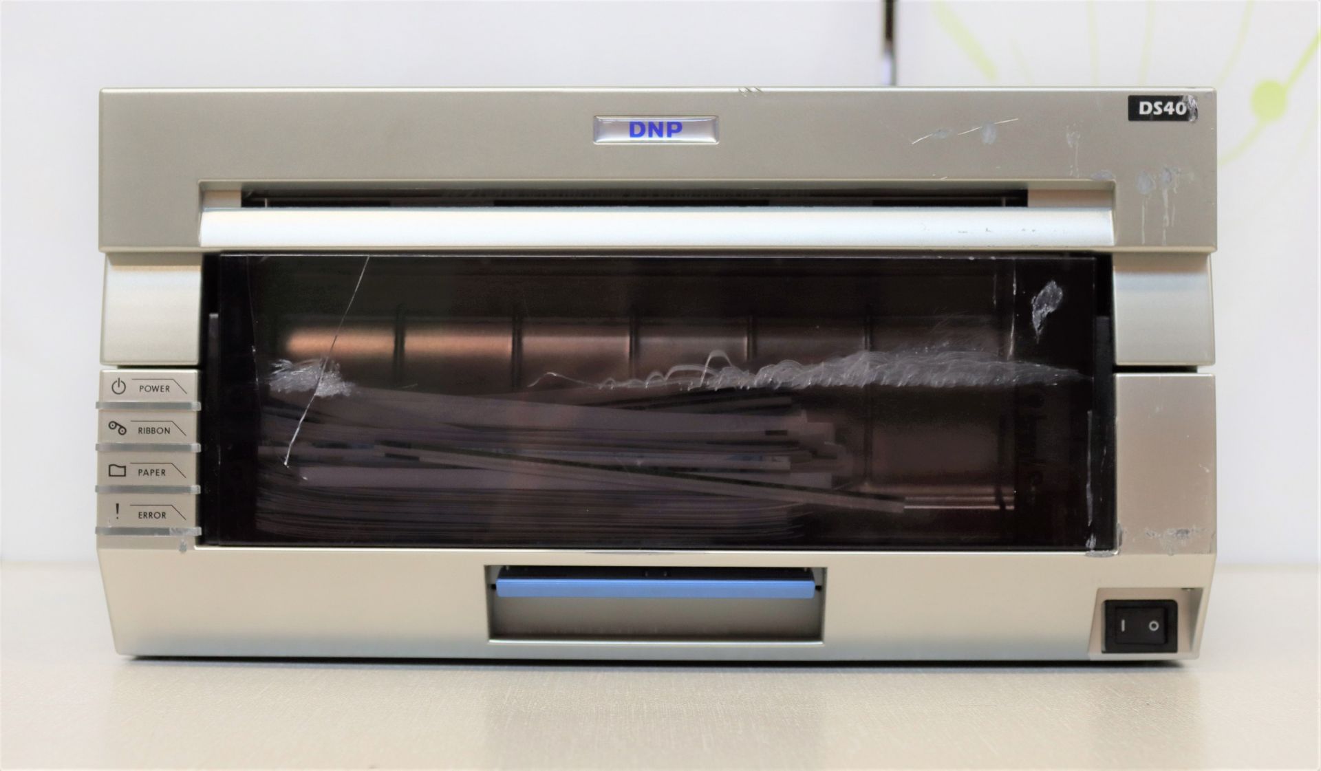 A pre-owned DNP DS40 photo printer (Damage to front panel).