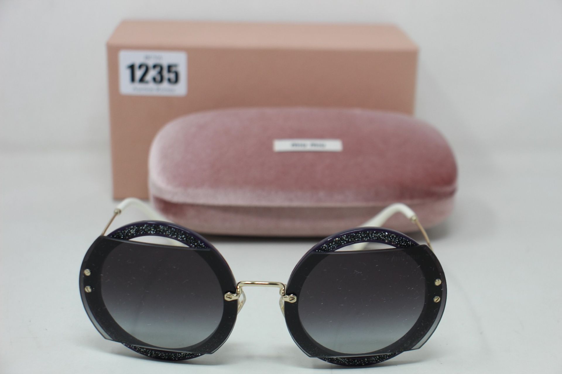 A pair of as new Miu Miu sunglasses.