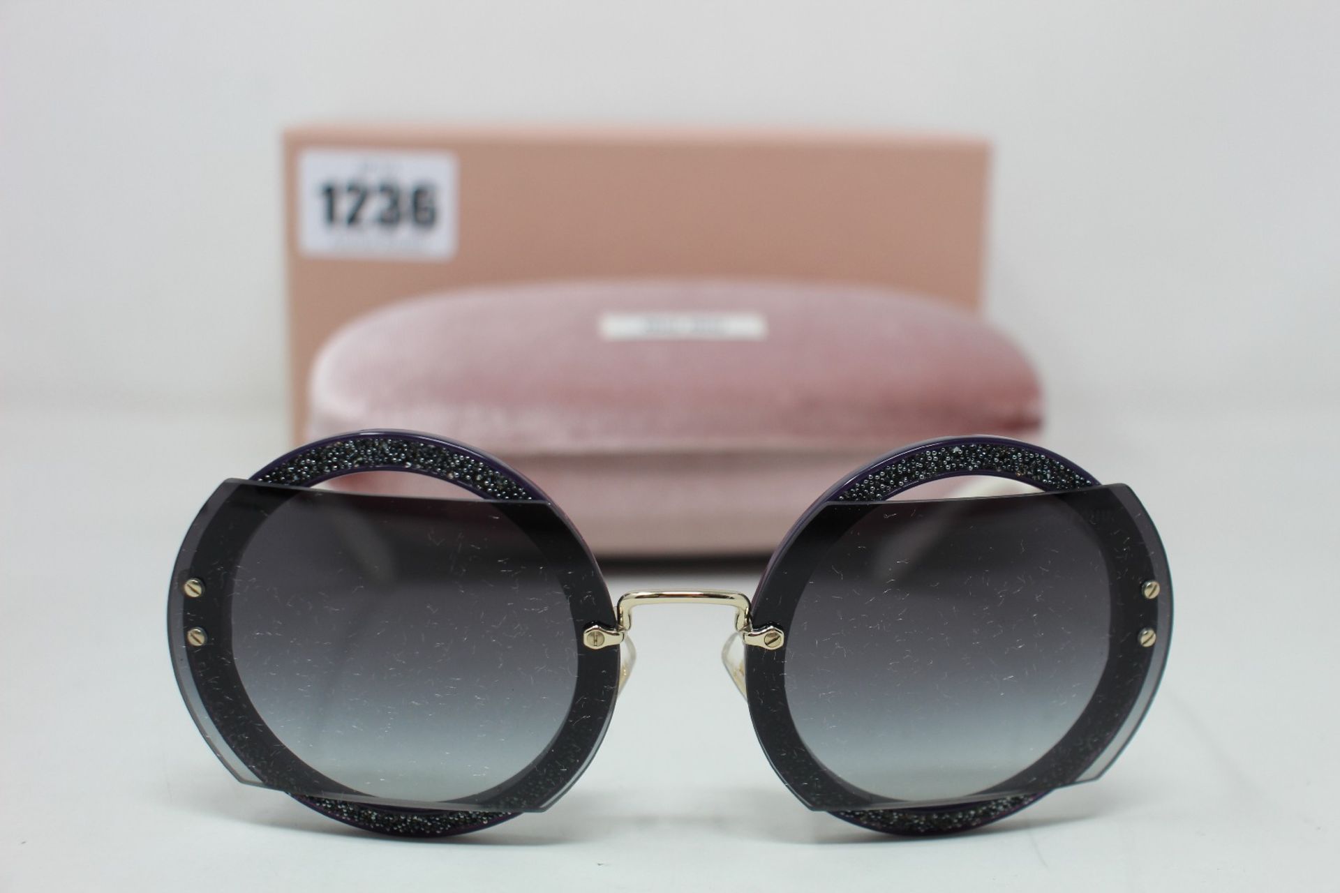 A pair of as new Miu Miu sunglasses.