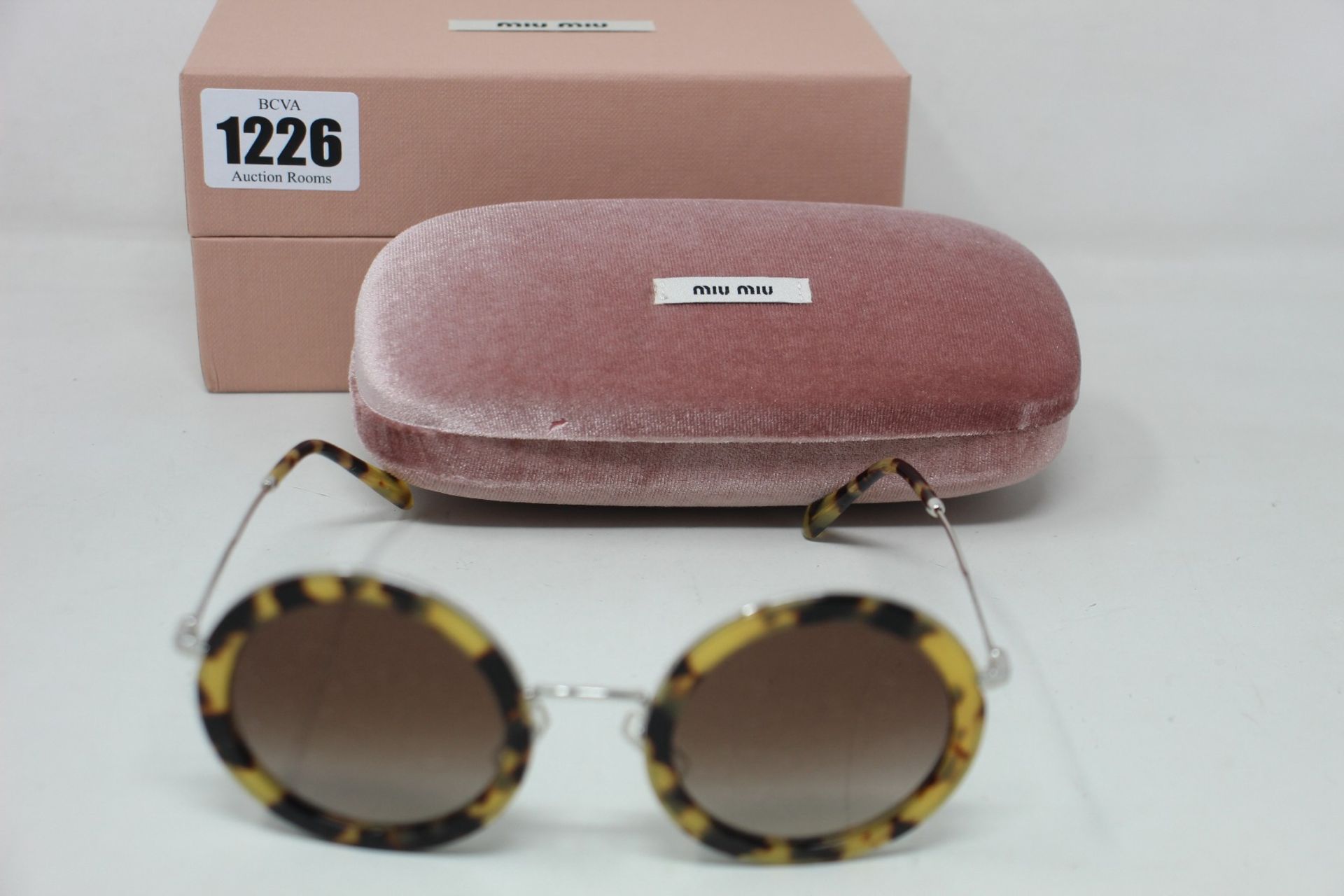 A pair of as new Miu Miu sunglasses.