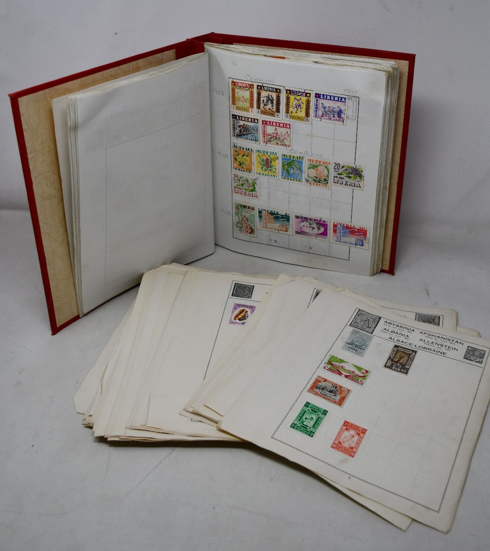 World stamp collection in two albums and loose pages.