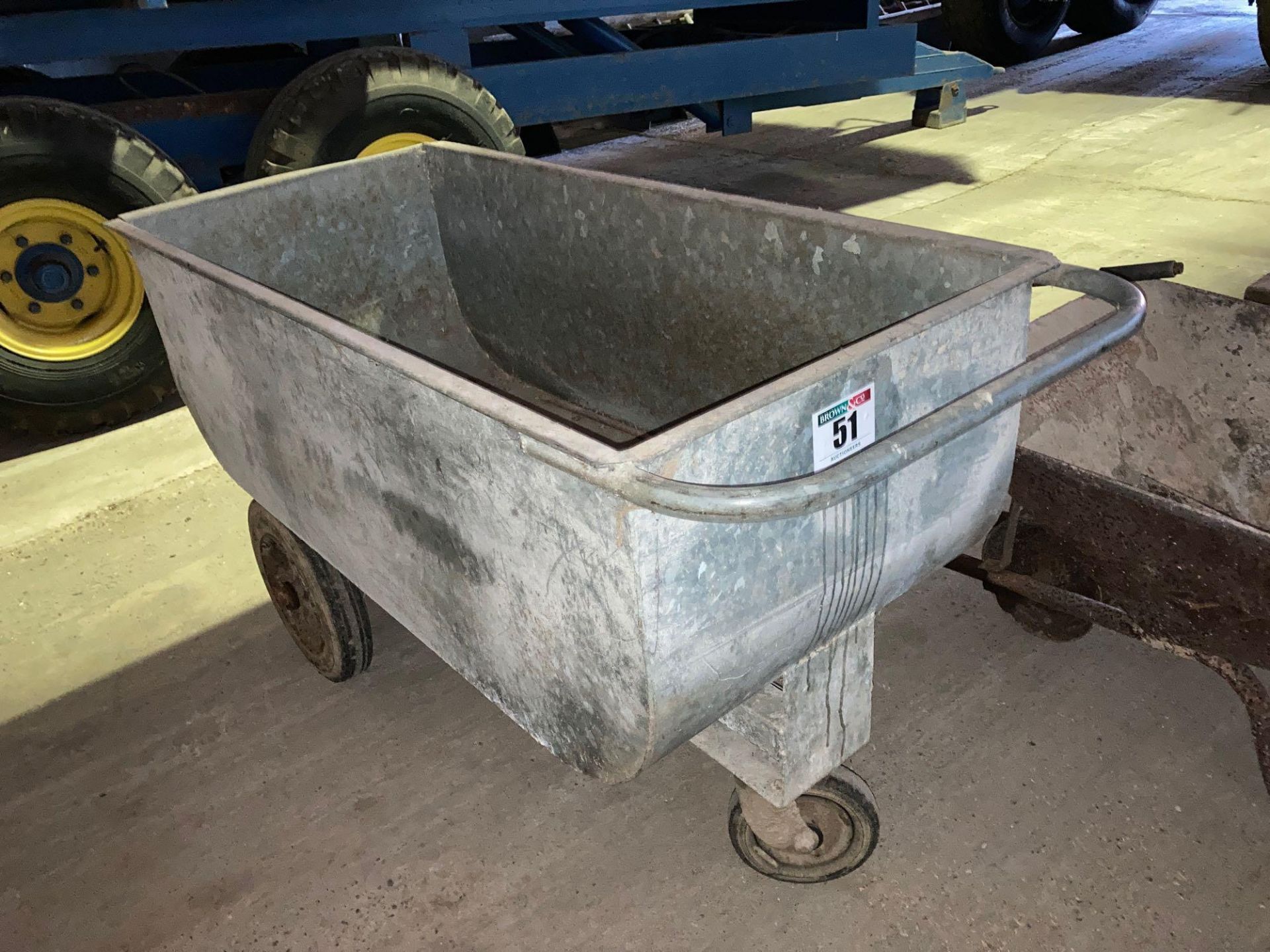 Galvanised feed barrow on wheels