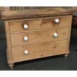 A late 19th/early 20th pine chest of two long over two short drawers, ceramic knobs (one missing),