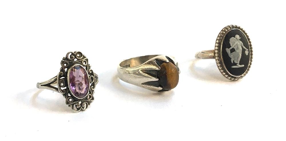 Three silver dress rings, one set with Tigers Eye, another an amethyst and the third small cameo