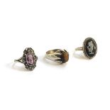 Three silver dress rings, one set with Tigers Eye, another an amethyst and the third small cameo