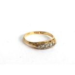 An 18ct gold dress ring set with 4 diamonds in an illusion setting, gross weight 2.2g, size N