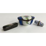Three Limoges petit main trinket boxes, one black with floral design, the others blue and white,