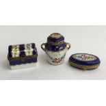 A set of three Limoges peint main trinket boxes, one in the form of a chest, the other an urn,