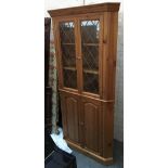 A modern pine glazed standing corner cupboard, 92x194cmH