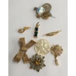 Mixed lot of brooches and badges to include a mother of pearl Bethlehem brooch, a brooch in the form
