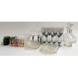 A mixed lot of glassware to include smoked glass wine glasses, several decanters, cut glass bowls