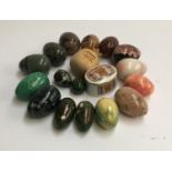 A collection of 16 mineral eggs; together with a carved wooden pomegranate and trinket dish