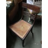 An early 19th century occasional chair, with lattice rail and generous caned seat, on fluted tapered