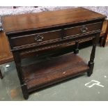 An oak sidetable two drawers over carved apron and undershelf, 95x45x81cmH