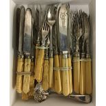 A set of plated bone handled fruit knives and forks; together with a similar set of crested fish