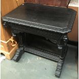 A heavily carved ebonised early 20th century sidetable, with single drawer, each corner with lion