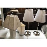 A pair of chrome table lamps, together with a further pair and one other