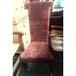 A Victorian Prie Dieu prayer chair, upholstered in red velvet fabric, on casters