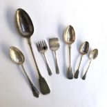 A small lot of silver comprising a George III teaspoon and desert spoon, a later teaspoon, etc,