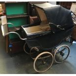 An antique coach built pram with canopy