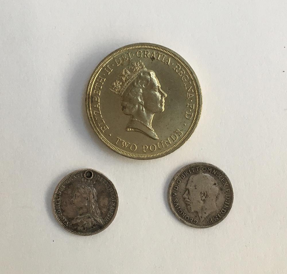 Two maundy threepence coins, 1887 and 1918; together with a 1986 commemorative Commonwealth games £2