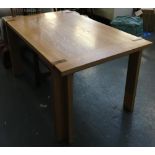 A contemporary light oak dining table, 150x92x76cm